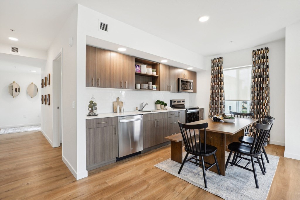 a kitchen and dining room with a table and chairs at The Mill on Maple Apartments, Oregon City, 97045