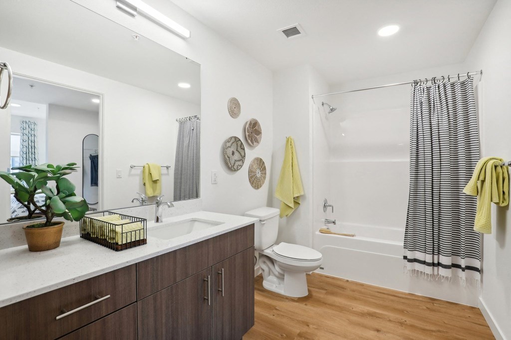 a bathroom with a sink and a toilet and a shower at The Mill on Maple Apartments, Oregon City