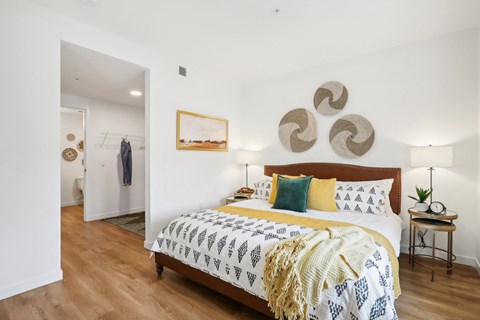 a bedroom with a bed and a painting on the wall
