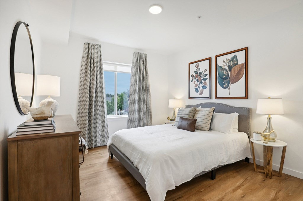 a bedroom with a bed and a dresser and a window at The Mill on Maple Apartments, Oregon City, 97045