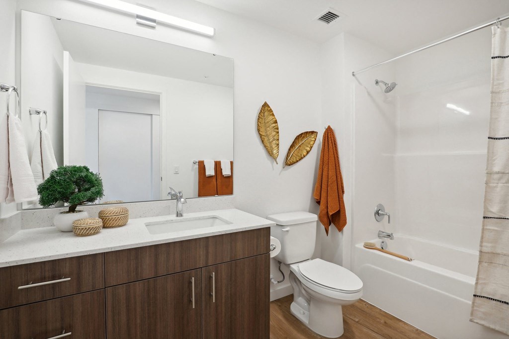 a bathroom with a toilet sink and shower and a mirror at The Mill on Maple Apartments, Oregon, 97045
