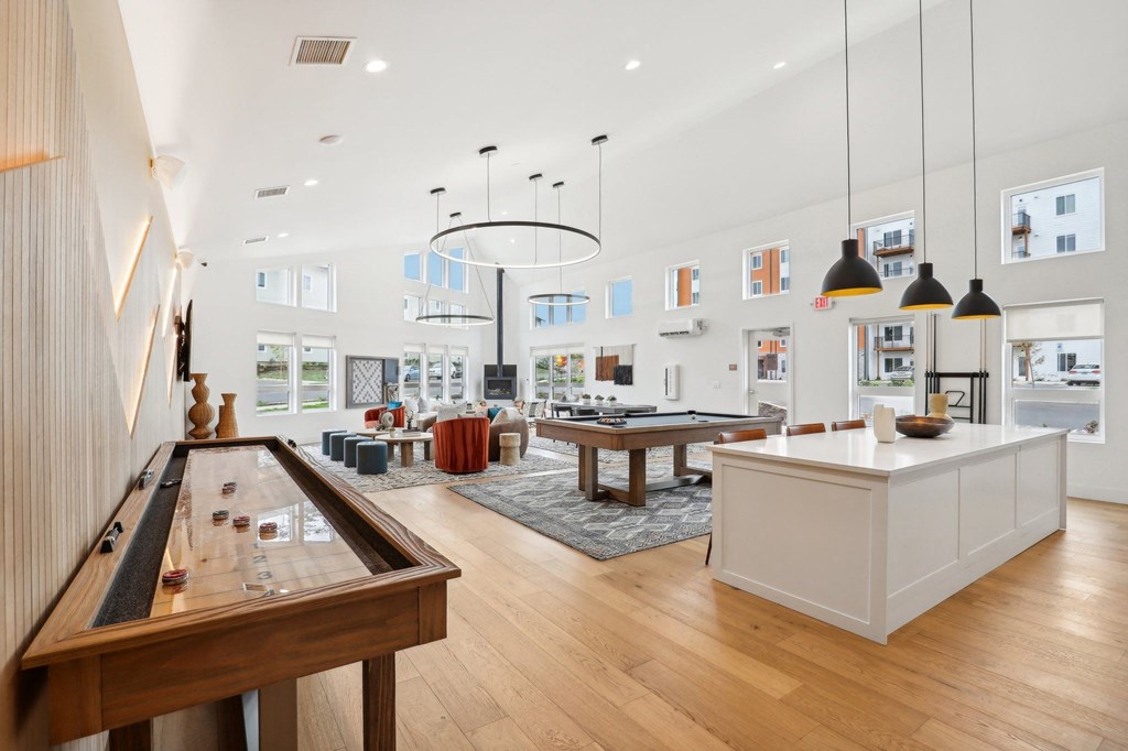 a living room with a ping pong table and a kitchen at The Mill on Maple Apartments, Oregon City, Oregon