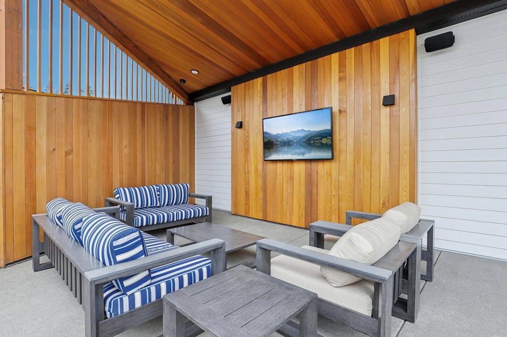 a patio with blue and white furniture and wooden walls at The Mill on Maple Apartments, Oregon City, OR