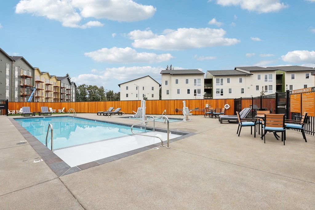 our apartments have a resort style pool with chairs and tables our apartments have a resort style pool with chairs and tables at The Mill on Maple Apartments, Oregon City, 97045