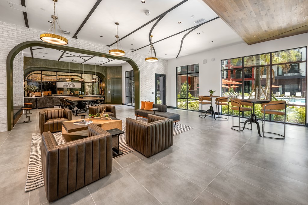 A modern living room with a curved wall and a large window.