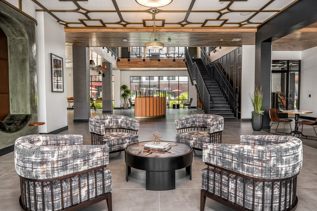 A large room with a lot of chairs and a table in the middle.