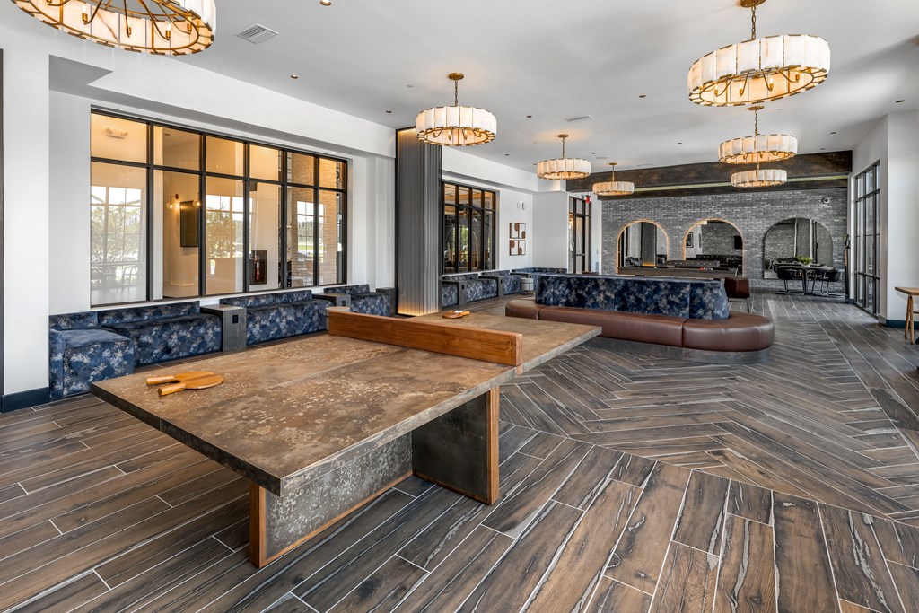 A large room with a long wooden table in the center.