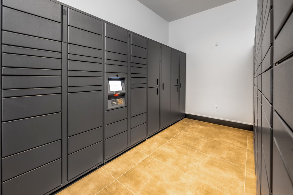 A row of black lockers in a room.