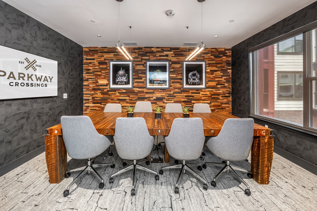 A conference room with a brick wall and a sign that says "Parkway Crossings.".
