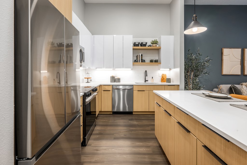 A modern kitchen with wooden cabinets and a white countertop.