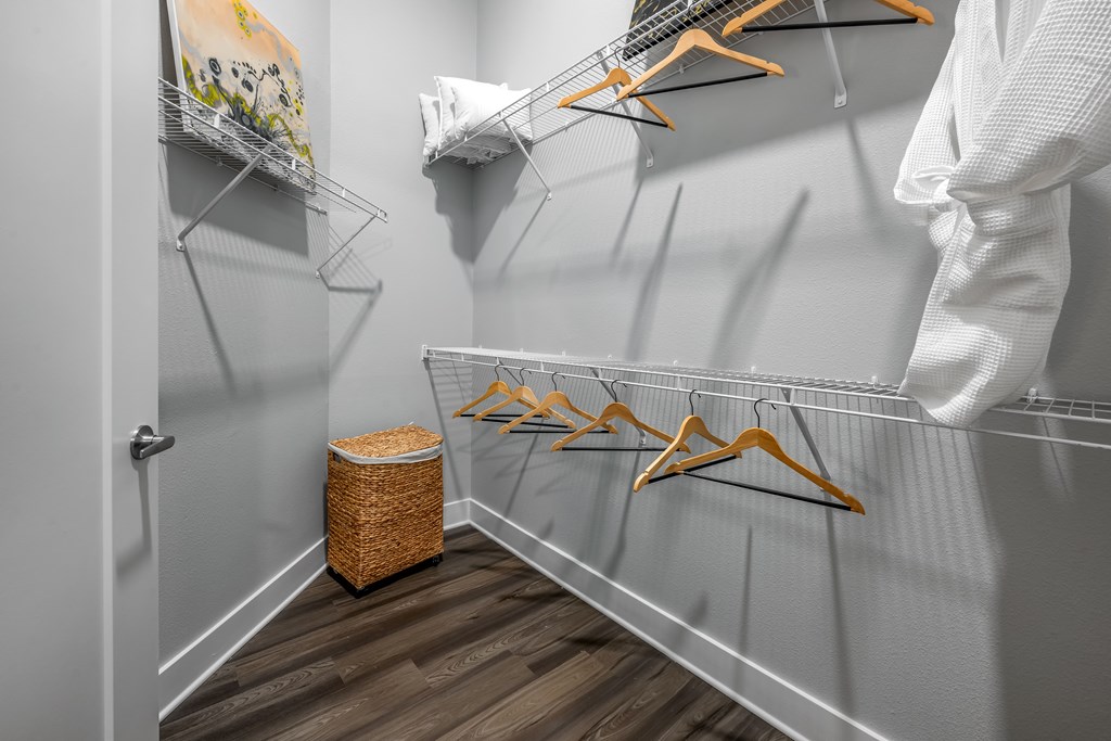 A person is hanging clothes on a rack in a room.