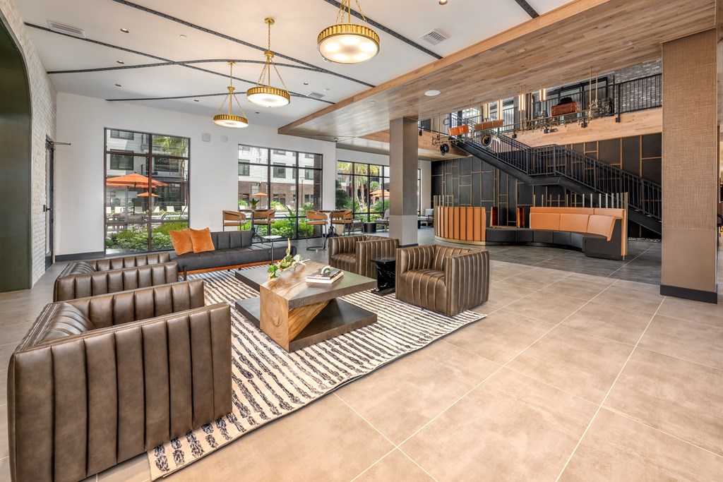 A modern living room with a brown leather sofa and a coffee table.