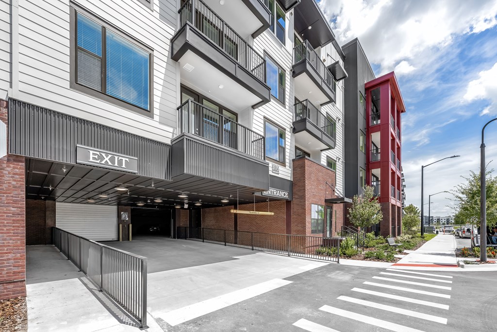 A modern building with a red door and a sign that says "EXIT".