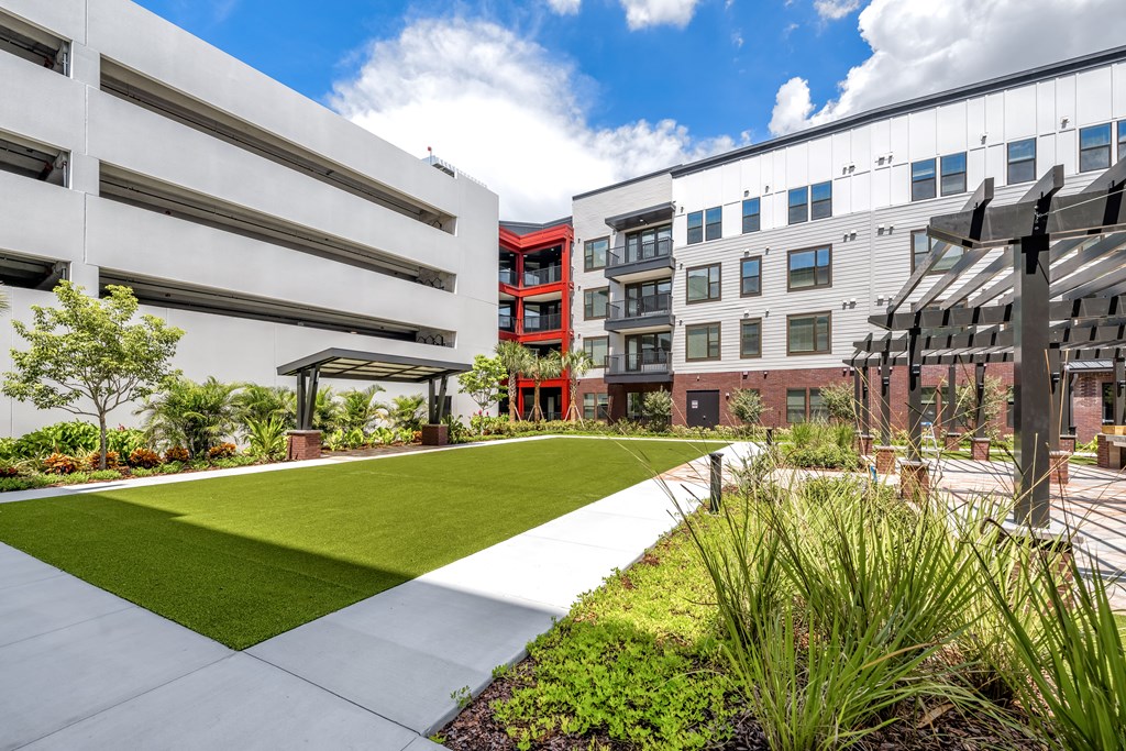A modern building with a green lawn in front.