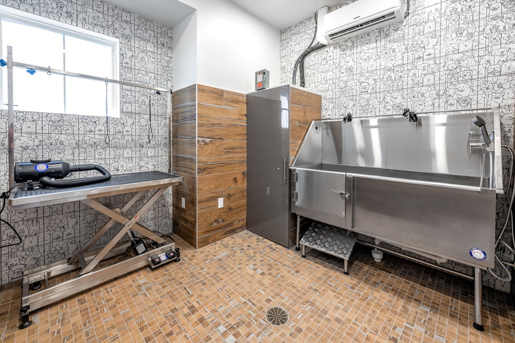 A kitchen with a tile floor and a stainless steel sink.