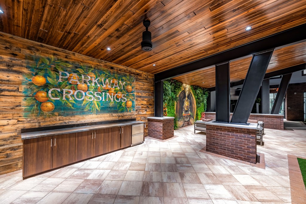 A wooden room with a mural of oranges and the words "Parkway Crossings" on the wall.