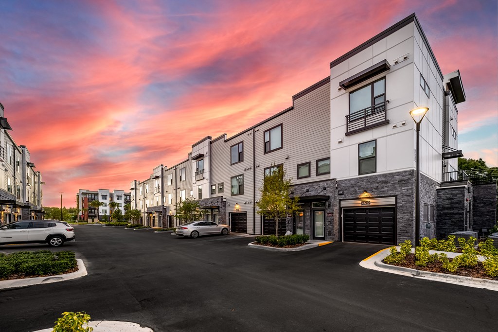 an empty street with buildings at sunset
