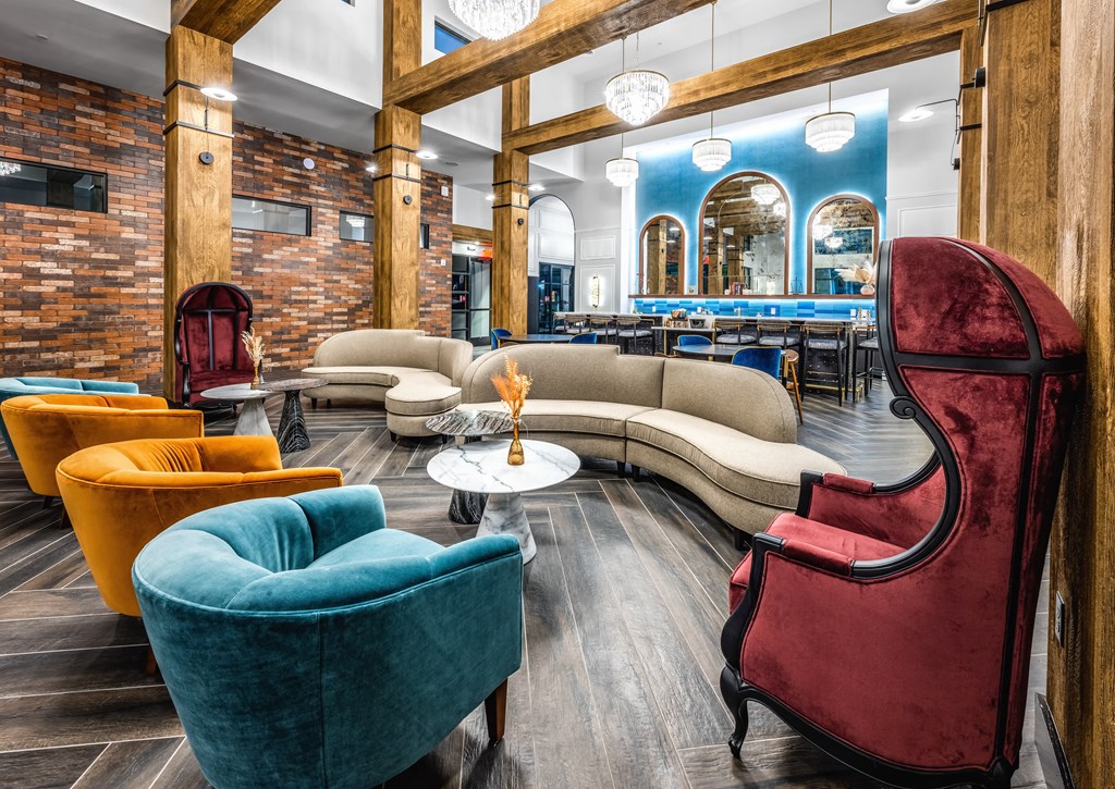 a lobby with couches and chairs and a bar at The Alibi at Lake Lilly, Ocoee, 34761