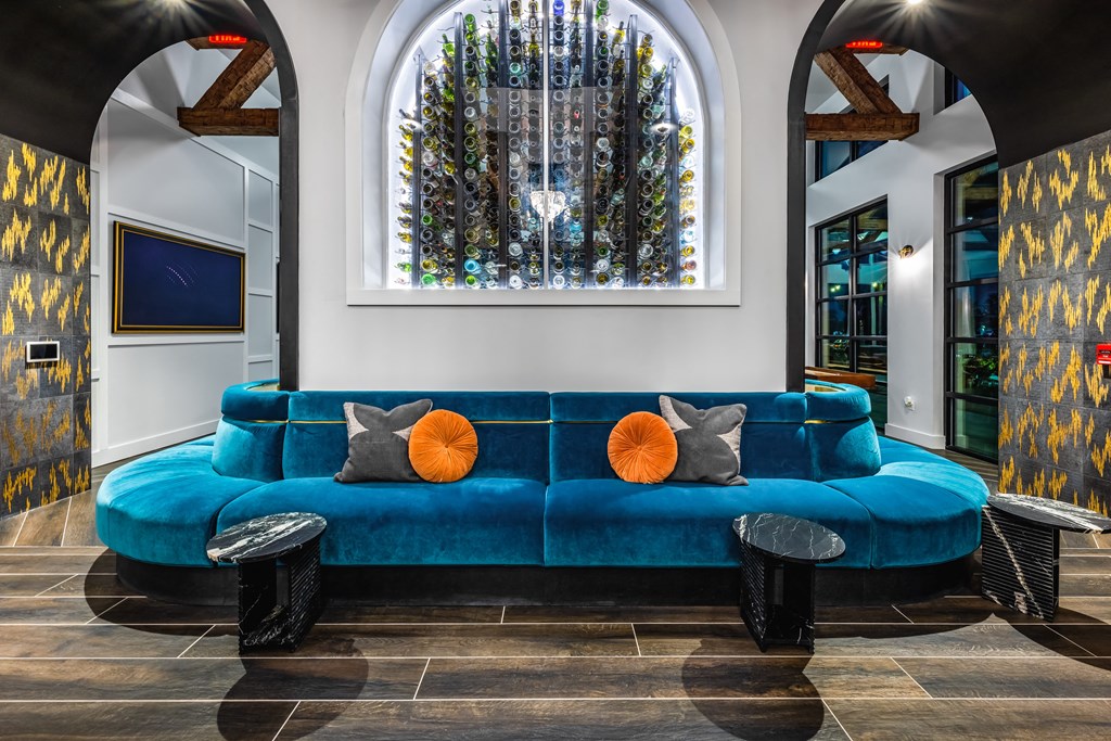 a living room with a blue couch and a large window