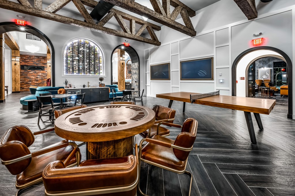 a game table in a room with chairs and tables at The Alibi at Lake Lilly, Florida, 34761