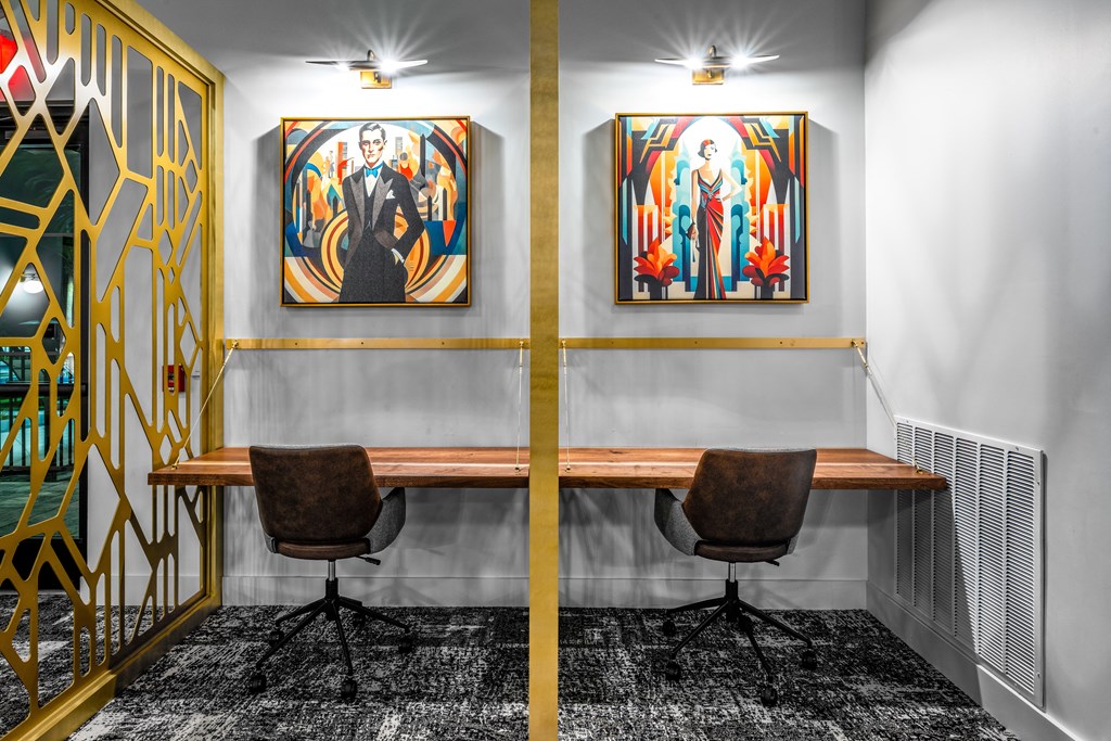a conference room with two paintings on the wall and a wooden desk