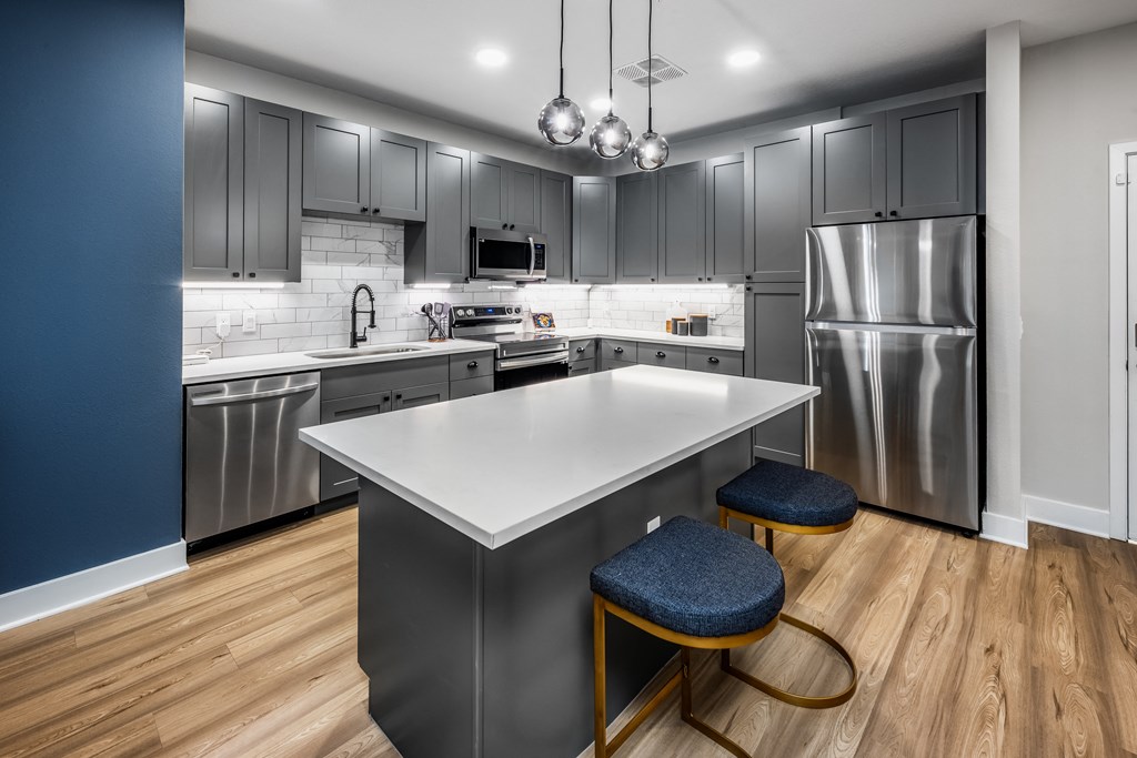 a kitchen with stainless steel appliances and a white counter top at The Alibi at Lake Lilly, Ocoee, FL