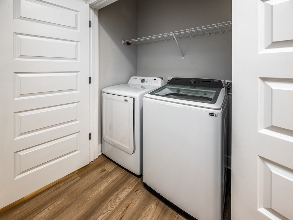 two washers and dryers in a laundry room with white doors at The Alibi at Lake Lilly, Ocoee, FL