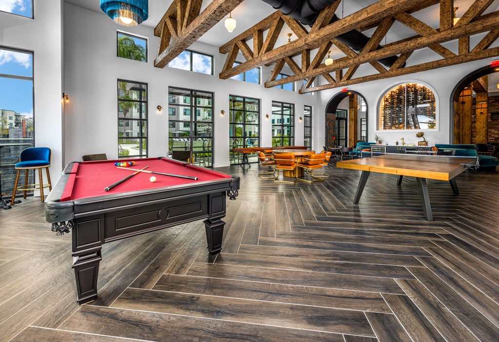 a games room with a pool table and tables at The Alibi at Lake Lilly, Ocoee, FL, 34761