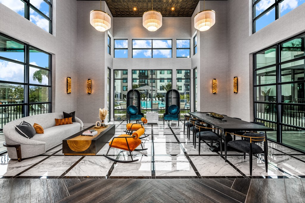 a large living room with large windows and a large table and chairs at The Alibi at Lake Lilly, Ocoee, FL, 34761
