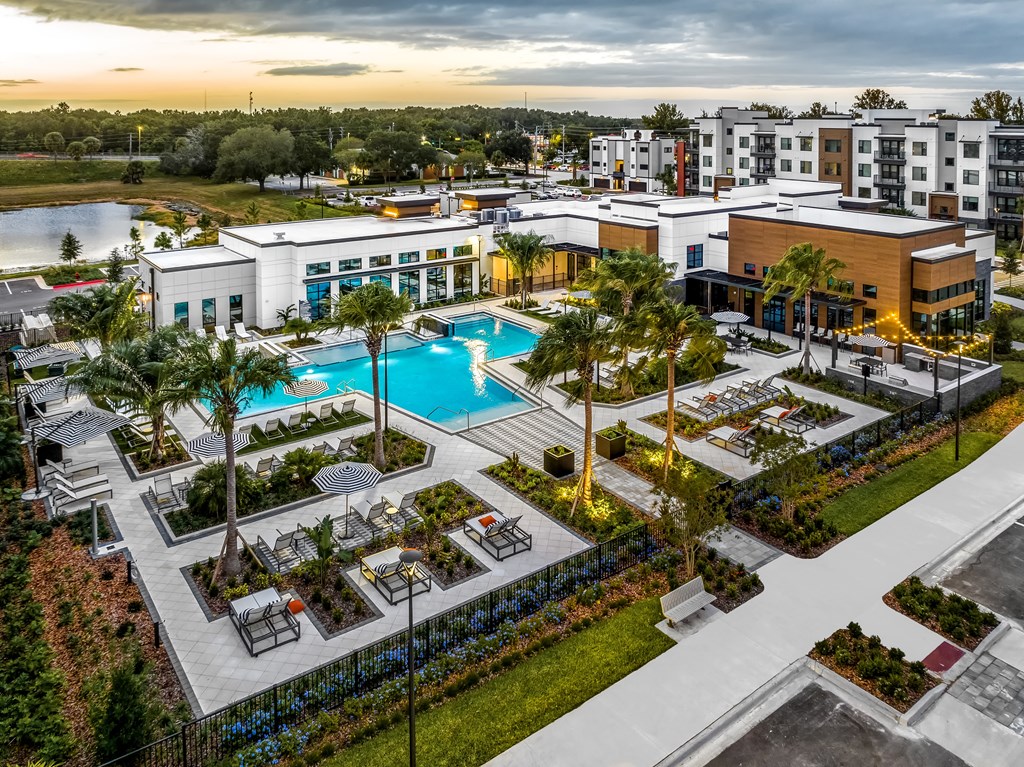 an aerial view of a resort with a pool and buildings at The Alibi at Lake Lilly, Ocoee, FL