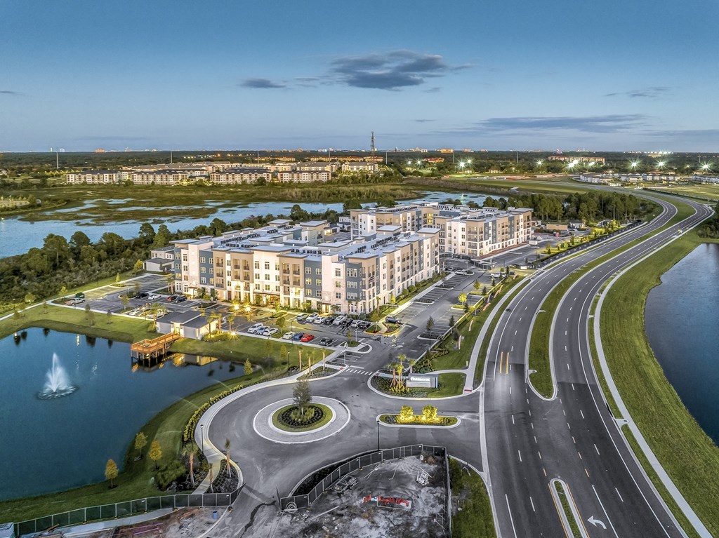 an aerial view of a large building next to a highway and a body of water at The Overlook, Winter Garden, FL