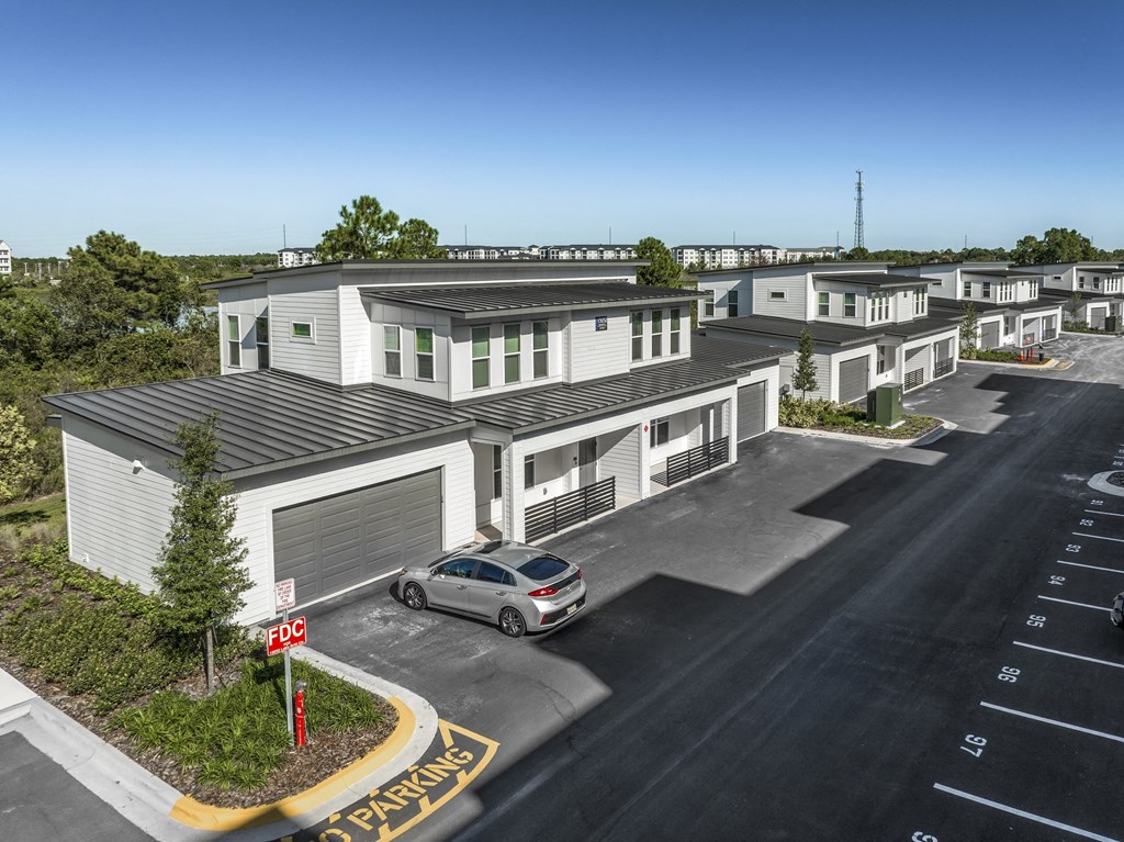 an aerial view of a group of houses with a car parked in front at The Overlook, Winter Garden, FL, 34787