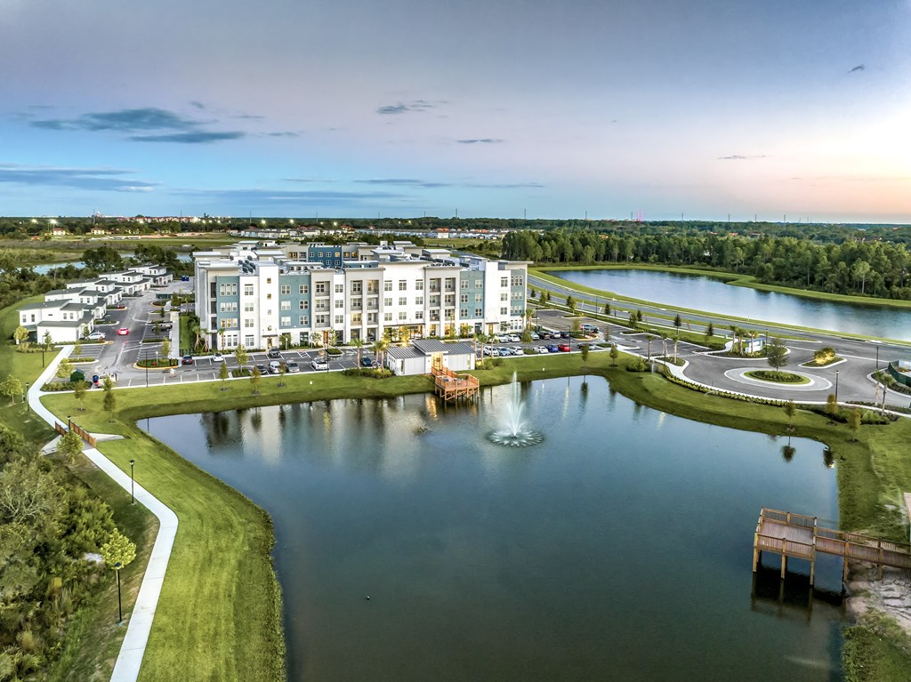 an aerial view of an apartment complex overlooking a lake at The Overlook, Winter Garden