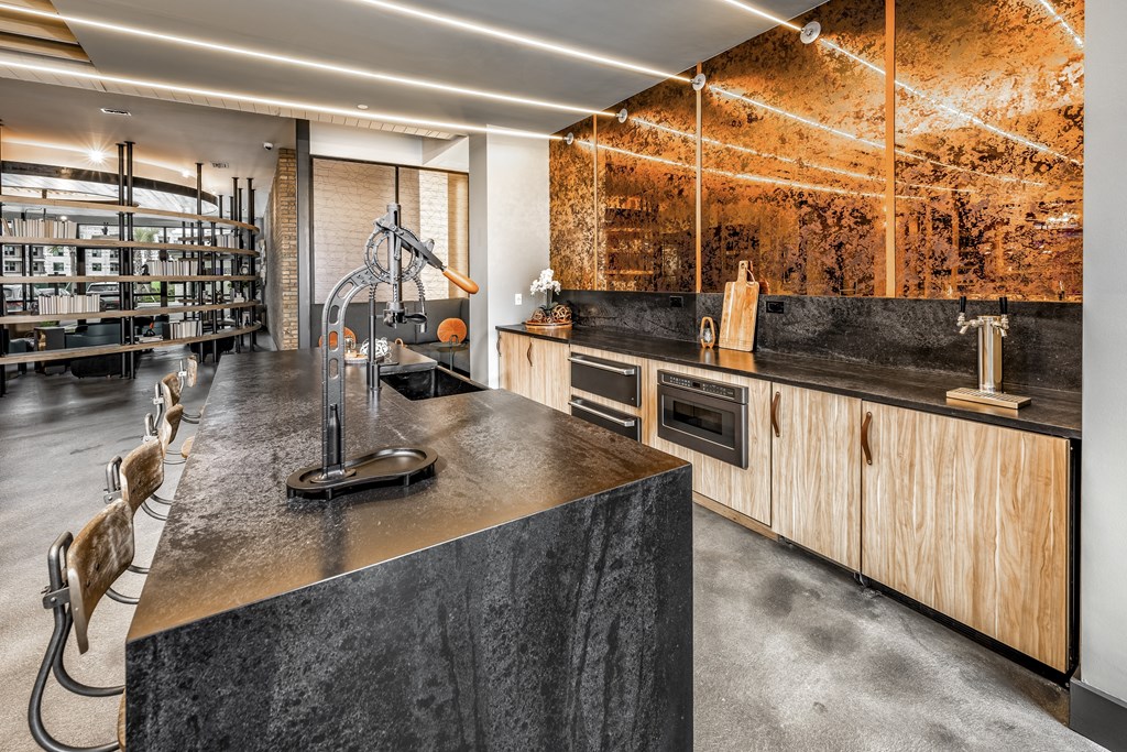 a kitchen with concrete countertops and wooden cabinets and a wine cellarat The Overlook, Winter Garden, FL, 34787