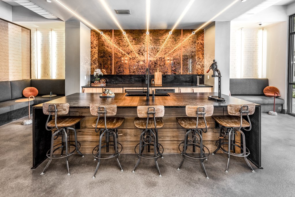 a large bar with bar stools in a room with a couch and a mirrorat The Overlook, Winter Garden, Florida