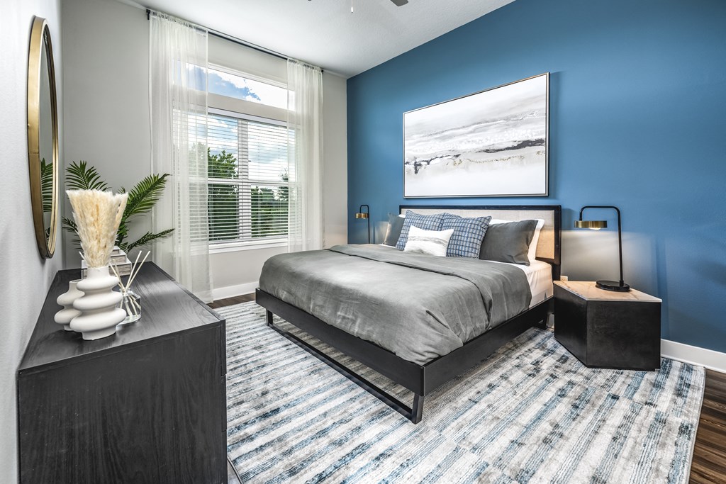 a bedroom with a bed and a large window at The Overlook, Winter Garden