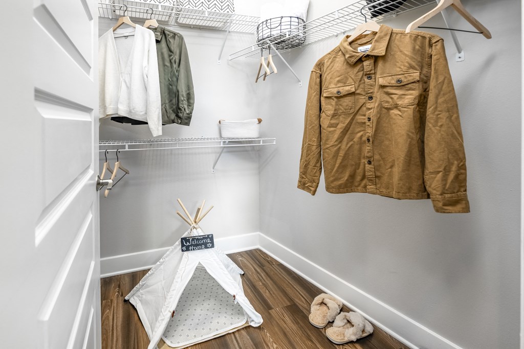 a walk in closet with a jacket hanging on the wall at The Overlook, Winter Garden, FL