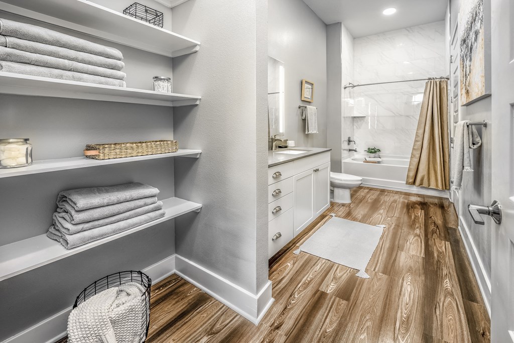a renovated bathroom with a shower and shelves with towelsat The Overlook, Winter Garden, 34787