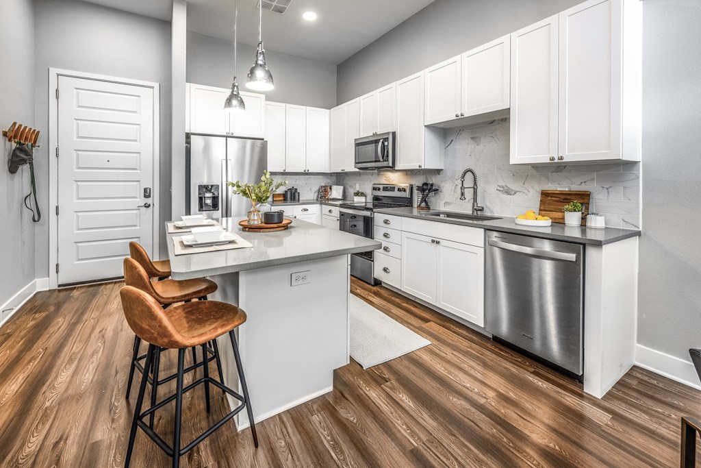 a kitchen with white cabinets and stainless steel appliancesat The Overlook, Florida