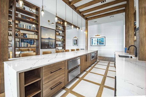 A modern kitchen with wooden cabinets and a white countertop.