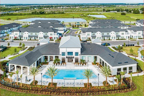 A large house with a pool in front.