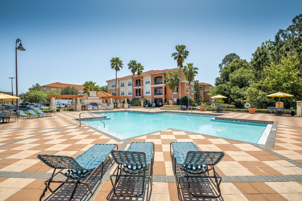 Pool area with view of the exterior building at Rapallo Apartments in Kissimmee, Florida