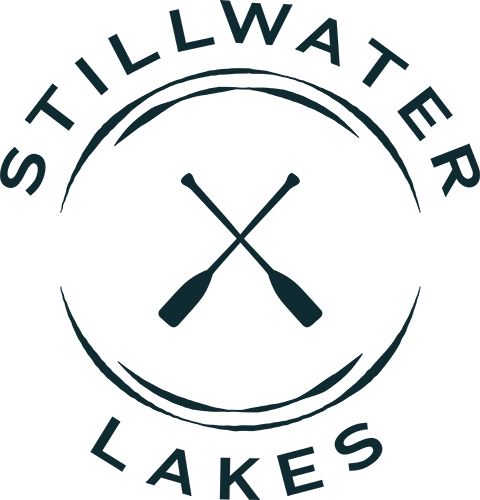Property entrance sign with crossed paddles logo at Stillwater Lakes Apartments, Kissimmee, 34744