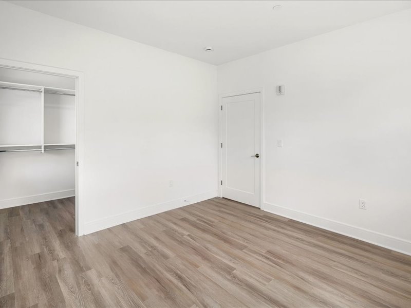 A room with a white door and a white wall.