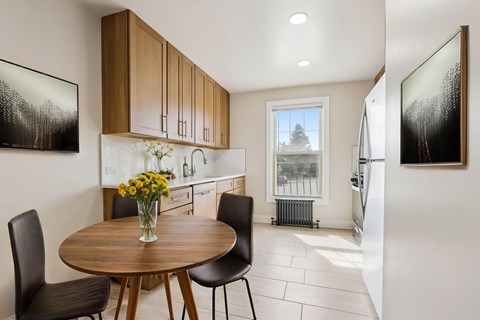 A modern kitchen with a table and chairs.