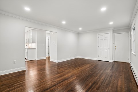 A room with wooden floors and white walls.