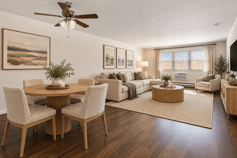 A living room with a dining table and chairs.