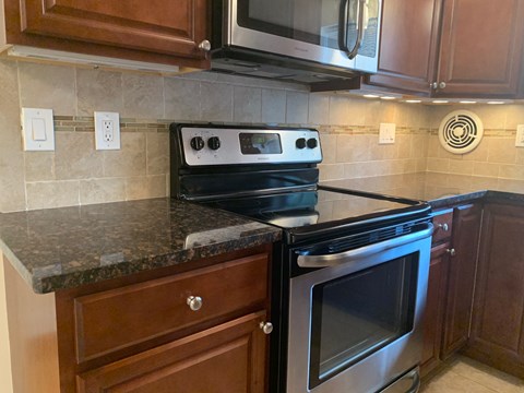 A black stove top oven with a silver handle is on a kitchen counter.