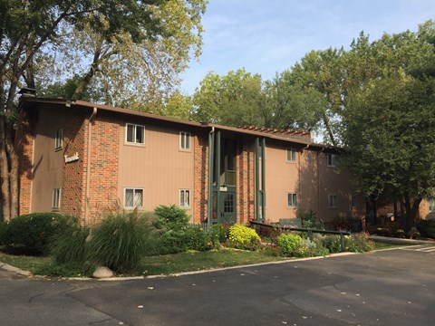 A building with a red brick facade and green trim.