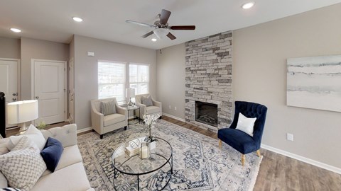A living room with a fireplace and a blue chair.